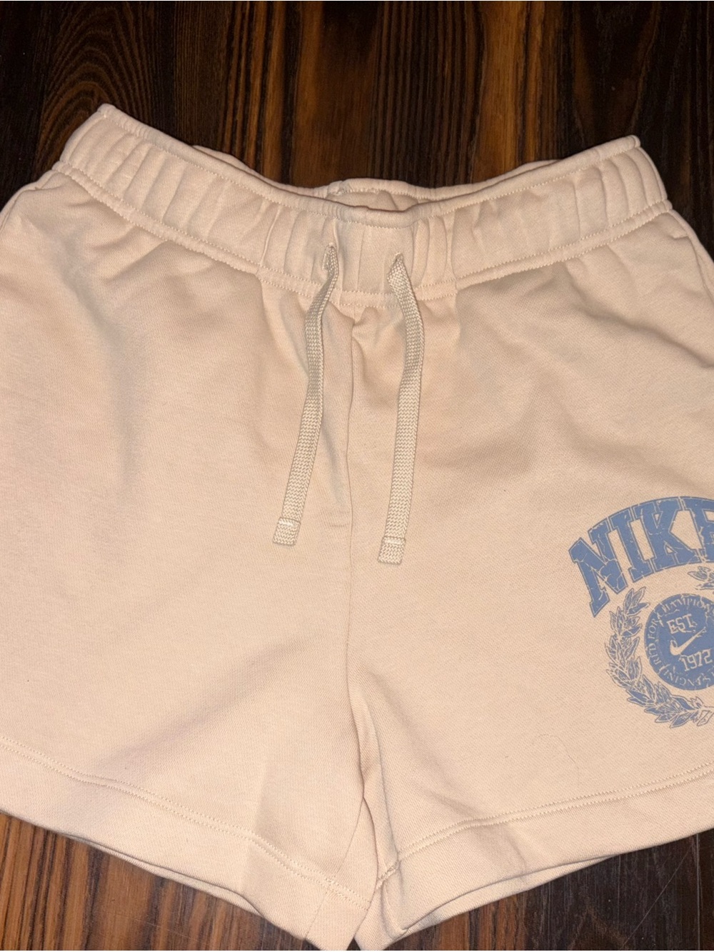 Nike Women's Cream Drawstring Athletic Shorts with Blue Logo